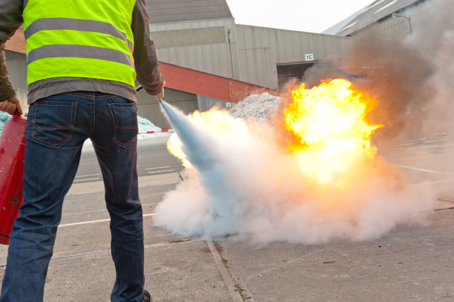 Safety officer demonstrating fire evacuation routes and emergency procedures during a training session
